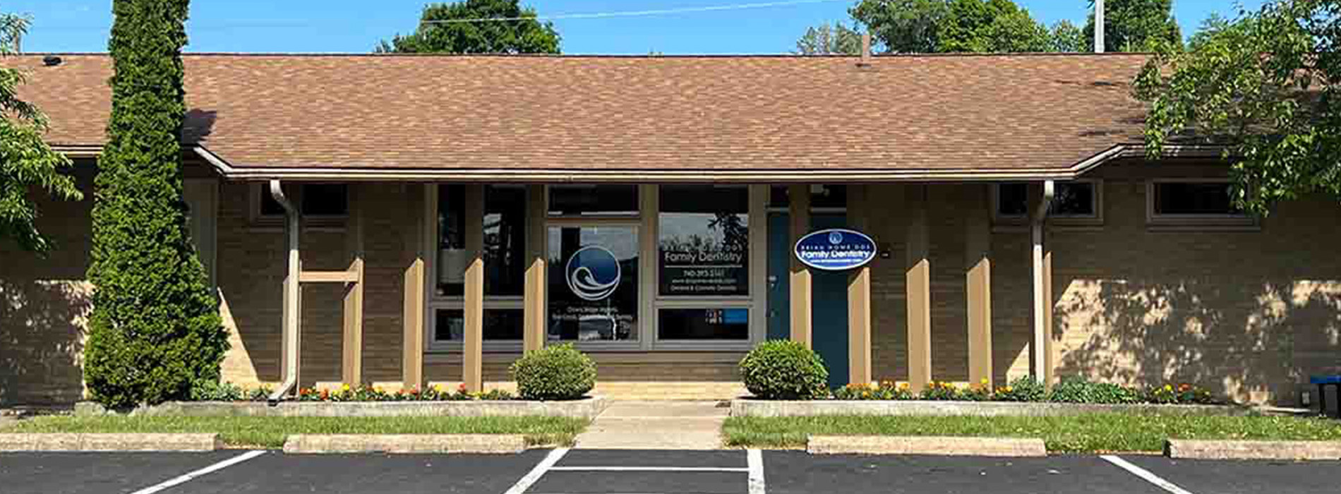 The image shows a building with a sign on the front, taken from a perspective that includes the sky above.